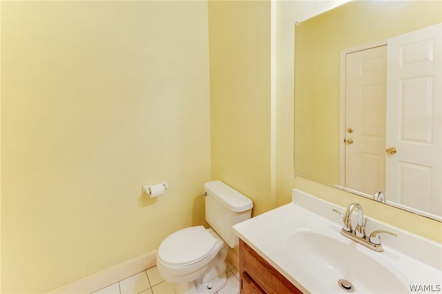 bathroom featuring tile patterned flooring, vanity, and toilet