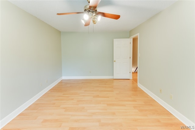 unfurnished room with ceiling fan, a baseboard heating unit, and light wood-type flooring