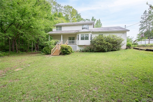 back of house with a yard and a porch