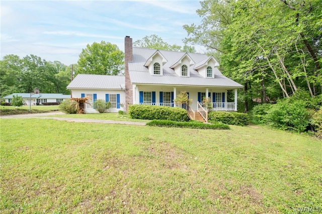 new england style home with a front lawn and covered porch