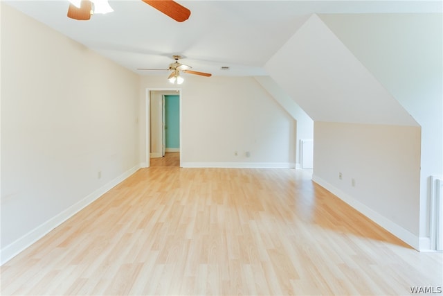 bonus room with ceiling fan, light hardwood / wood-style floors, and vaulted ceiling