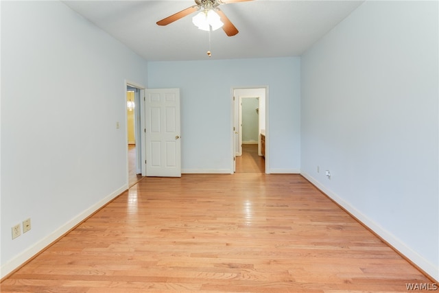 unfurnished bedroom with ensuite bath, ceiling fan, and light wood-type flooring