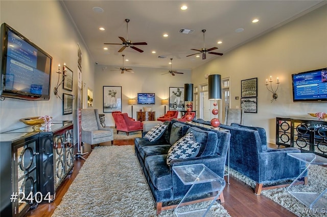 living area with visible vents, wood finished floors, and recessed lighting