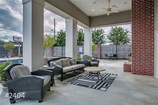 view of patio with outdoor lounge area, ceiling fan, and fence