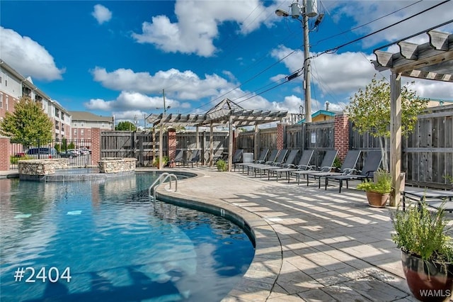 pool with a patio area, fence, and a pergola