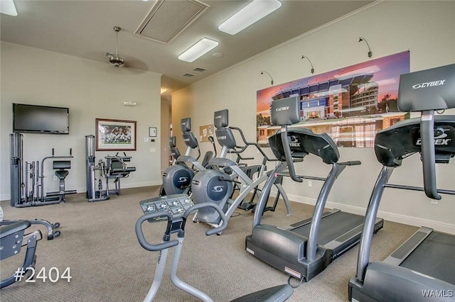 exercise room with attic access, baseboards, and crown molding