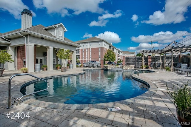 community pool featuring a patio and fence