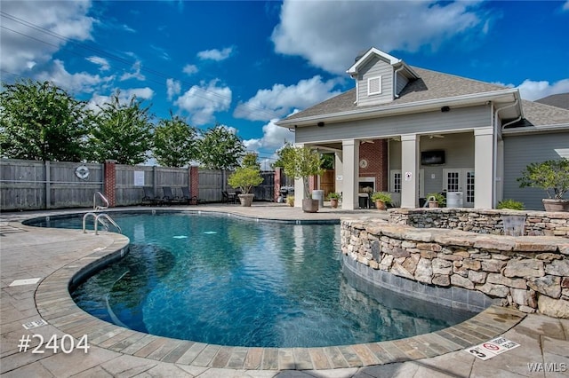 pool featuring a fenced backyard and a patio