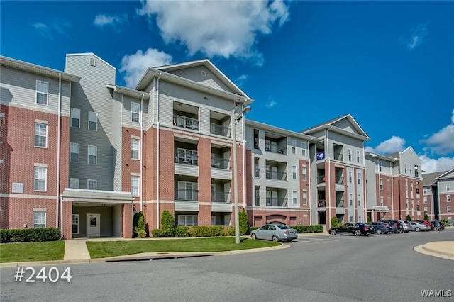 view of building exterior with uncovered parking