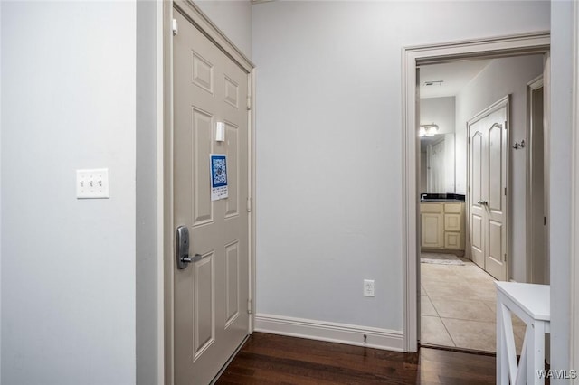 interior space featuring light wood-type flooring and baseboards