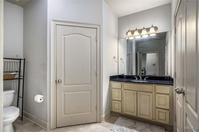 full bathroom featuring baseboards, vanity, toilet, and tile patterned floors