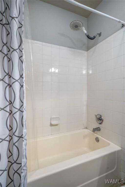 bathroom featuring shower / bath combo with shower curtain