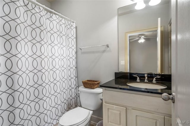 full bath with curtained shower, vanity, and toilet