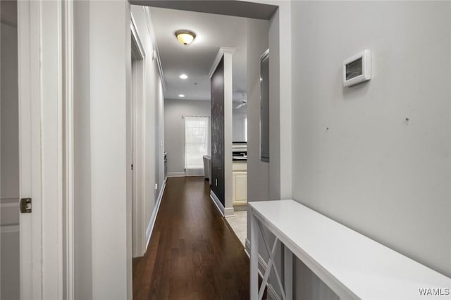 corridor with recessed lighting, dark wood finished floors, and baseboards