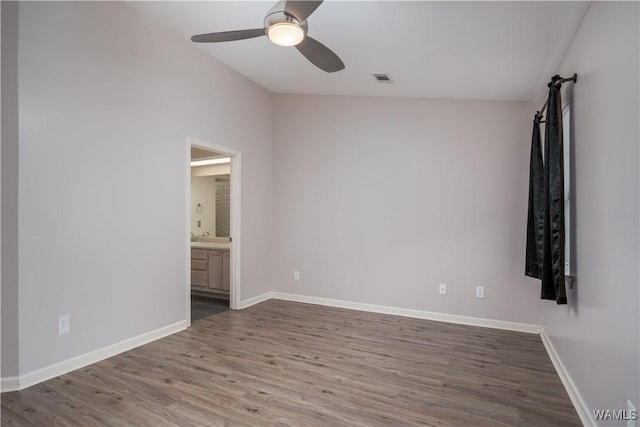 unfurnished room with ceiling fan and wood-type flooring