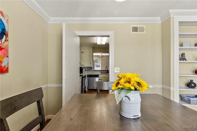 dining area featuring built in shelves, visible vents, and ornamental molding