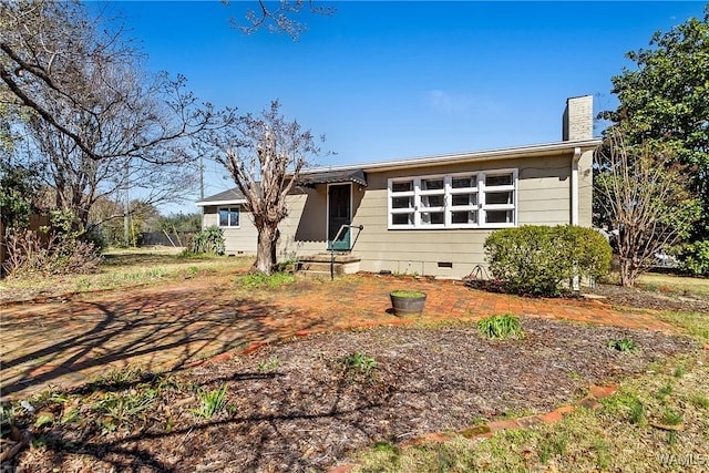 ranch-style home featuring crawl space and a chimney