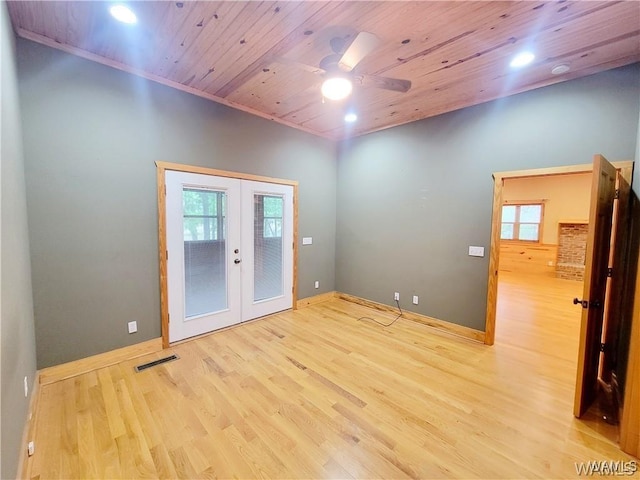 unfurnished room with wooden ceiling, wood finished floors, visible vents, baseboards, and french doors