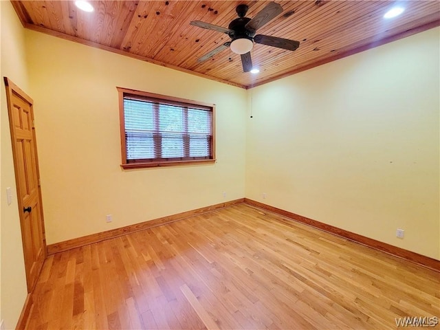 spare room with wooden ceiling, light wood-style flooring, and baseboards