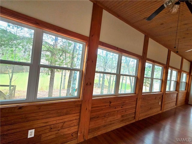 unfurnished sunroom featuring a ceiling fan