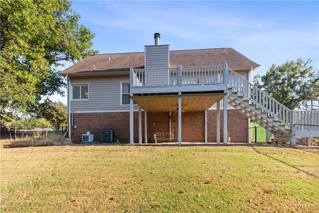 rear view of house featuring a yard, a deck, and central AC unit