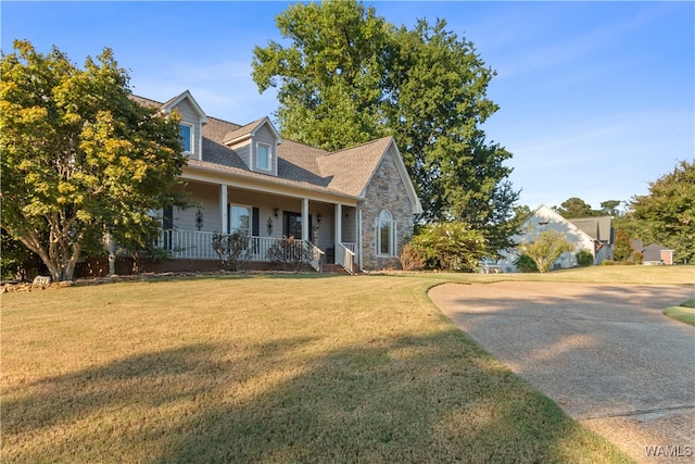 cape cod house featuring a porch and a front lawn