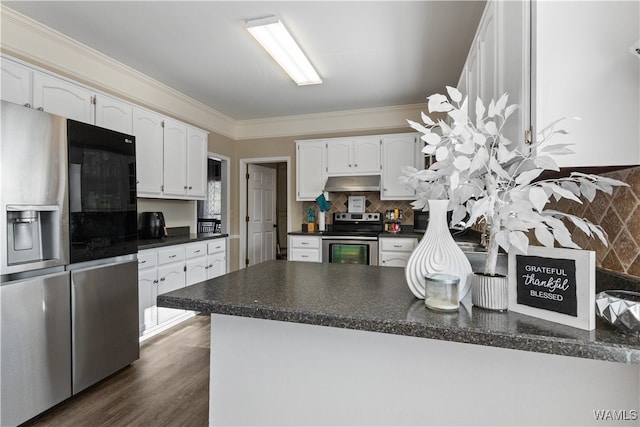 kitchen with white cabinets, ornamental molding, appliances with stainless steel finishes, kitchen peninsula, and extractor fan