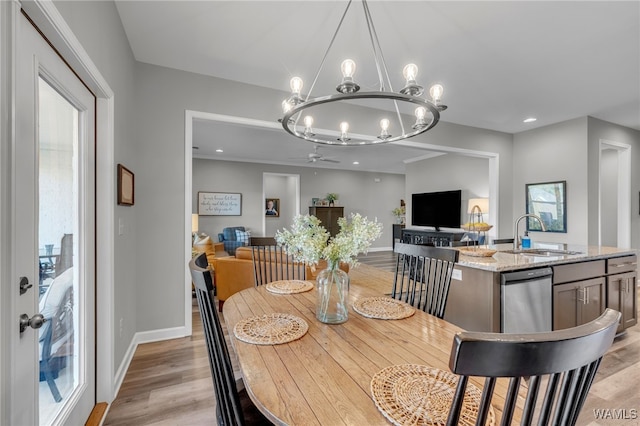 13930 Sullivan Blvd, Northport, AL 35475 - dining area with light wood-style flooring, ceiling fan with notable chandelier, baseboards, and recessed lighting