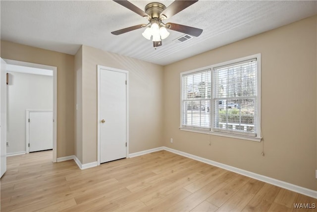 empty room with light wood-style flooring, baseboards, and ceiling fan