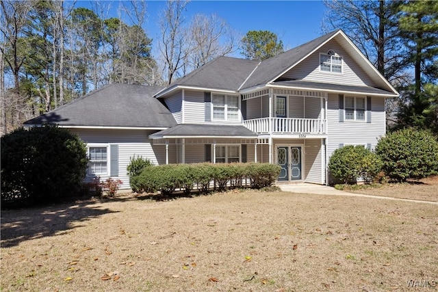 view of front of home featuring french doors and a balcony