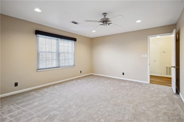 carpeted empty room featuring recessed lighting, visible vents, ceiling fan, and baseboards