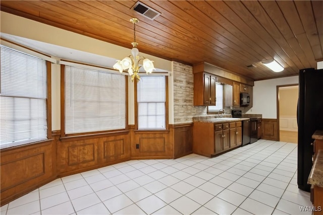 kitchen with a wainscoted wall, black appliances, wooden ceiling, and visible vents