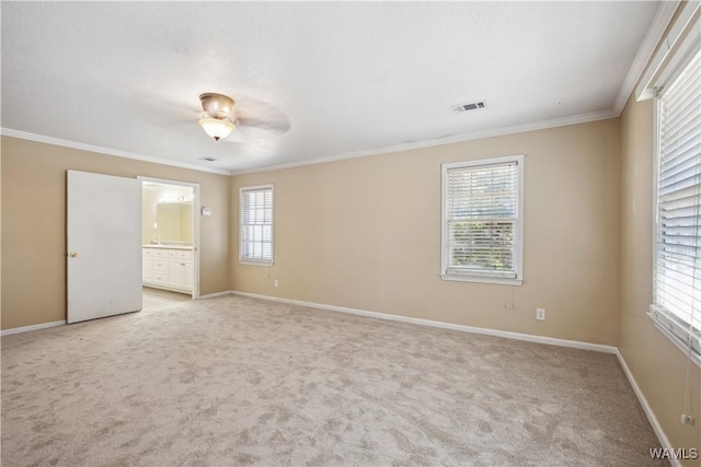 empty room with light carpet, baseboards, visible vents, and crown molding