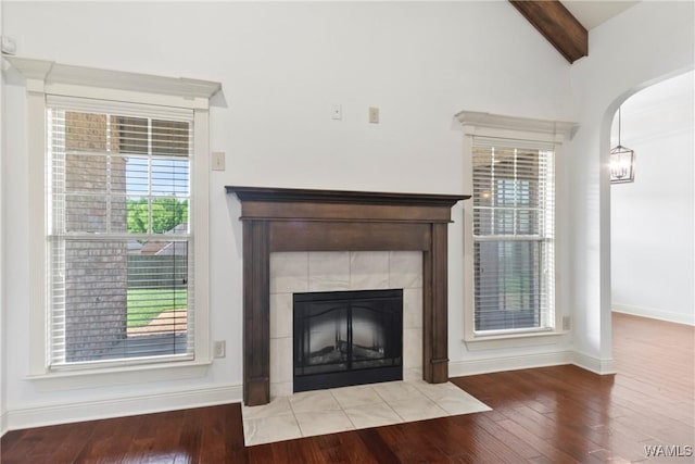 11542 Woodford St, Northport, AL 35475 - detailed view of arched walkways, wood finished floors, a tiled fireplace, and baseboards