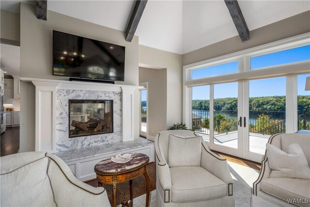 1231 Diamond Point Cir, Tuscaloosa, AL 35406 - living room with a high end fireplace, vaulted ceiling with beams, wood finished floors, and french doors