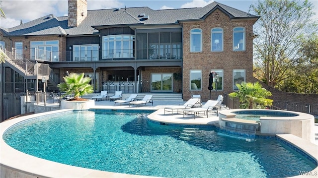 1231 Diamond Point Cir, Tuscaloosa, AL 35406 - rear view of property with brick siding, a pool with connected hot tub, outdoor dry bar, and a patio area