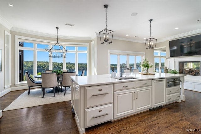 1231 Diamond Point Cir, Tuscaloosa, AL 35406 - kitchen featuring a healthy amount of sunlight, light countertops, an inviting chandelier, and a sink