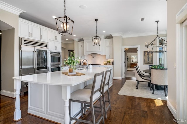 1231 Diamond Point Cir, Tuscaloosa, AL 35406 - kitchen with a notable chandelier, stainless steel appliances, light countertops, and ornamental molding