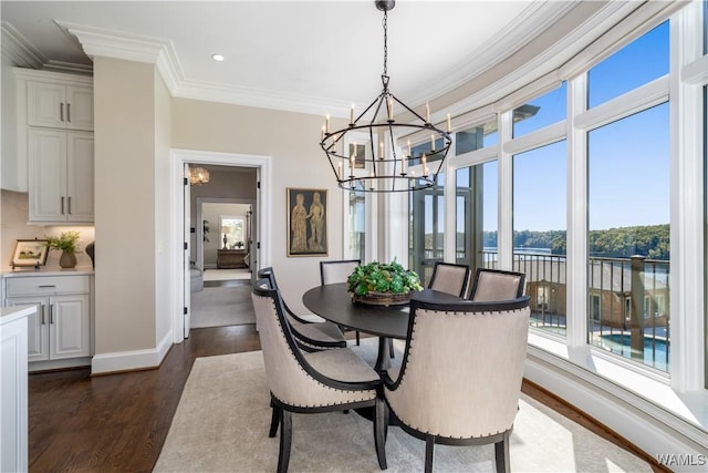 1231 Diamond Point Cir, Tuscaloosa, AL 35406 - dining room featuring dark wood-style floors, a healthy amount of sunlight, and an inviting chandelier