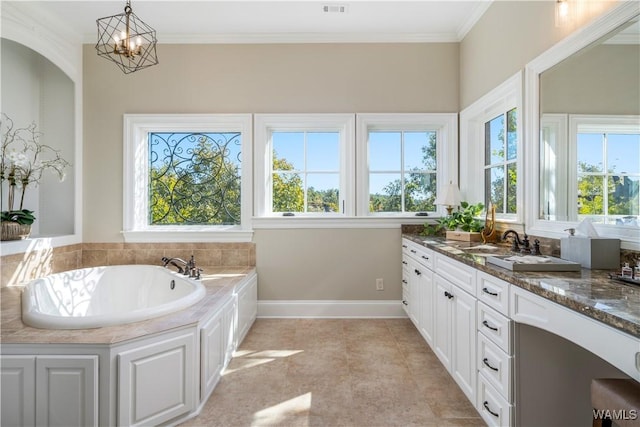 1231 Diamond Point Cir, Tuscaloosa, AL 35406 - full bath with vanity, a bath, baseboards, crown molding, and a notable chandelier