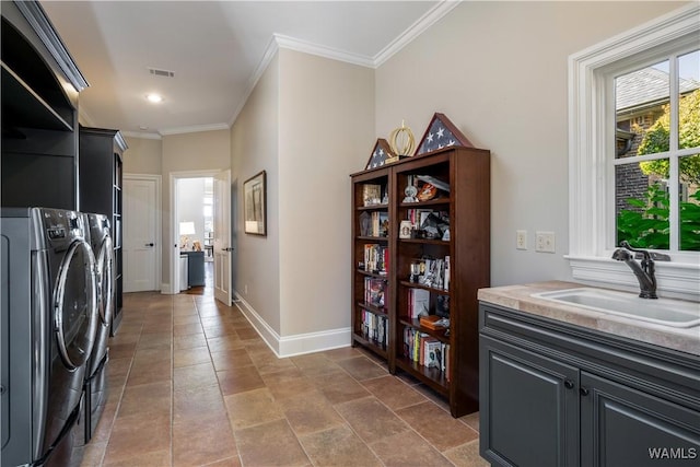 1231 Diamond Point Cir, Tuscaloosa, AL 35406 - laundry area featuring visible vents, a sink, washer and dryer, crown molding, and baseboards