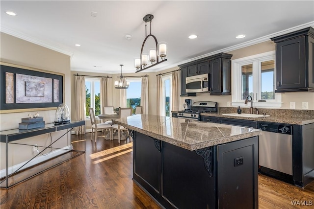 1231 Diamond Point Cir, Tuscaloosa, AL 35406 - kitchen with a center island, tile counters, ornamental molding, stainless steel appliances, and a sink