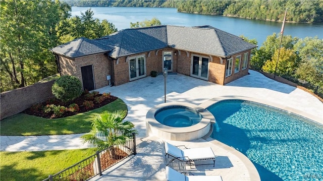 1231 Diamond Point Cir, Tuscaloosa, AL 35406 - view of pool featuring a pool with connected hot tub, a water view, fence, french doors, and a patio area
