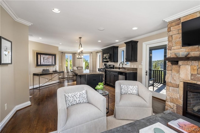 1231 Diamond Point Cir, Tuscaloosa, AL 35406 - living room with crown molding, baseboards, recessed lighting, a fireplace, and dark wood-style floors