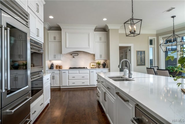 1231 Diamond Point Cir, Tuscaloosa, AL 35406 - kitchen featuring a sink, appliances with stainless steel finishes, white cabinetry, crown molding, and a chandelier