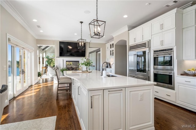 1231 Diamond Point Cir, Tuscaloosa, AL 35406 - kitchen featuring visible vents, open floor plan, stainless steel appliances, white cabinetry, and a sink