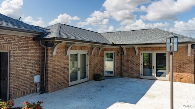 1231 Diamond Point Cir, Tuscaloosa, AL 35406 - rear view of property with french doors, a patio, brick siding, and roof with shingles