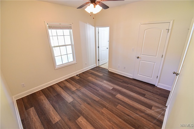 unfurnished bedroom with ceiling fan and dark hardwood / wood-style floors