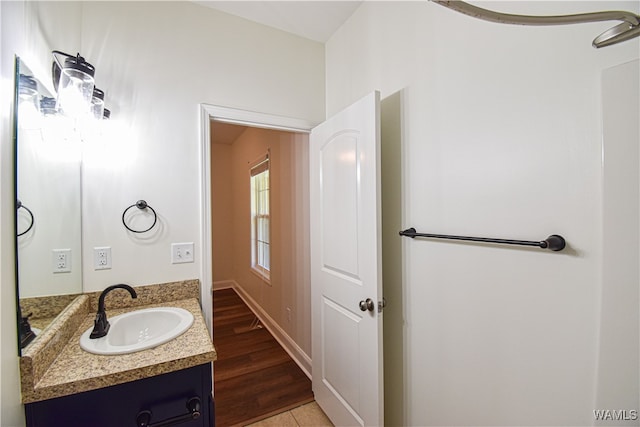 bathroom with hardwood / wood-style floors and vanity