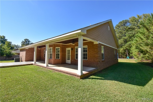 back of house featuring ceiling fan, a patio area, and a lawn